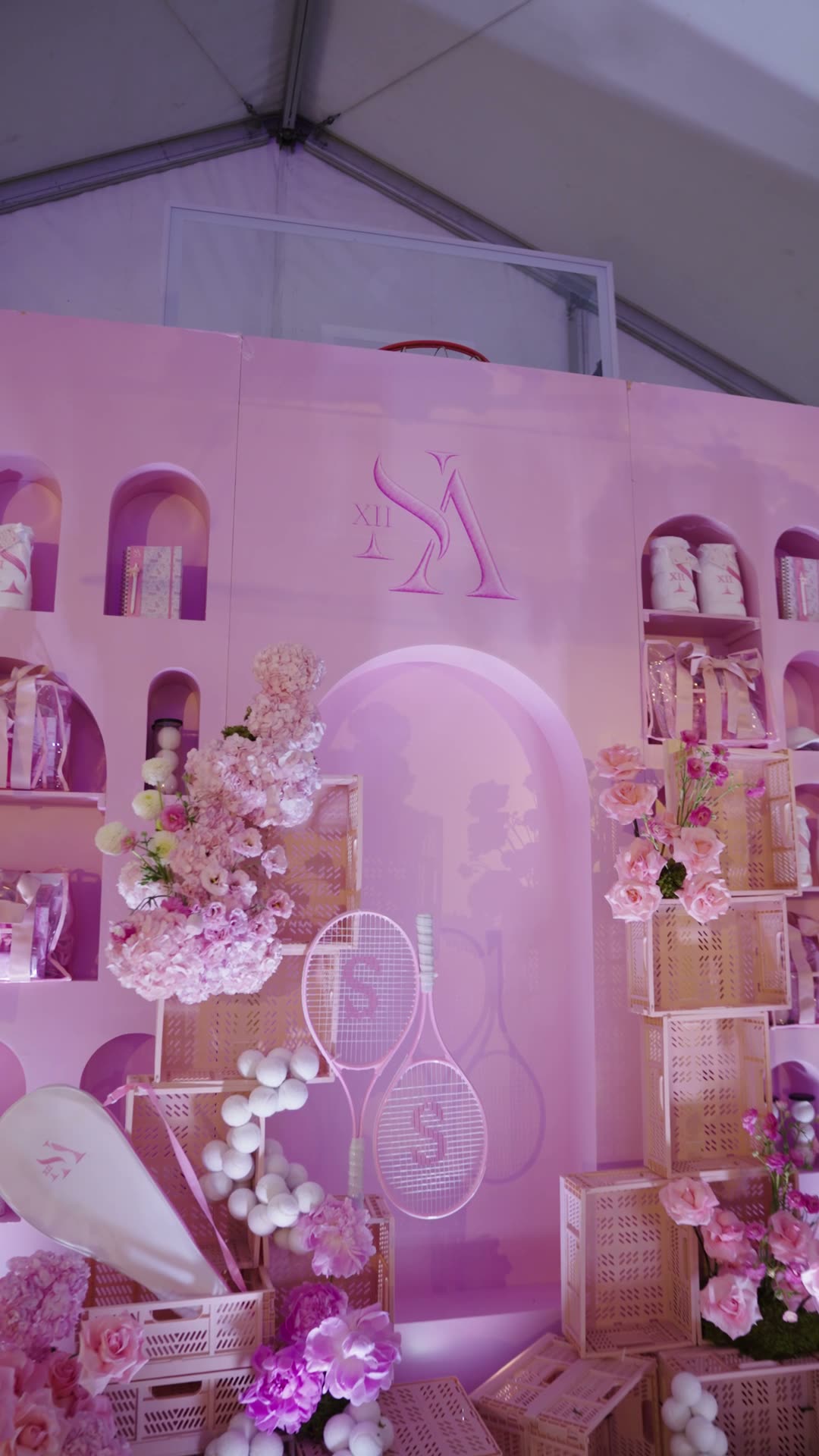 Pink arch shelving wall with floral rackets